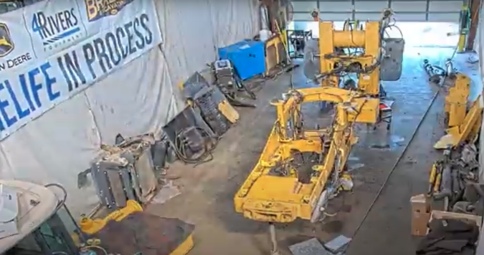 A 624J loader, completely deconstructed, in a service bay at the Colorado Springs 4Rivers location.